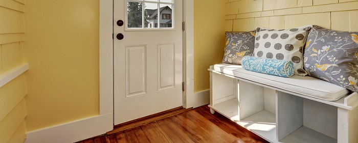 a small mudroom with a white bench